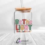 Be The Light Christmas UVDTF Sticker design on a ceramic mug mockup, ideal for vibrant customized craft gifts.