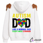 White hoodie mockup with an Autism Dad DTF transfer design, featuring yellow and black distressed text, a colourful puzzle-piece heart, and the phrase “Like a normal dad except much stronger.”