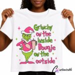 White T-shirt with a colourful Christmas character DTF transfer design and the phrase “Grinchy On The Inside Bougie On The Outside.”