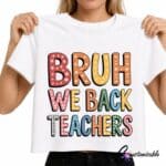 White T-shirt with a colourful “Bruh We Back Teachers” DTF transfer design featuring bold patterned letters in red, orange, yellow, blue, green, and pink.
