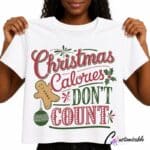 White T-shirt with red and green “Christmas Calories Don’t Count” DTF transfer design featuring a gingerbread man, bauble, holly leaves, and festive typography.