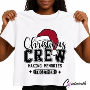 White T-shirt with “Christmas Crew Making Memories Together” DTF transfer design featuring black lettering, a red Santa hat, and festive accents.