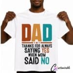White T-shirt with a colourful “Dad Thanks For Always Saying Yes When Mom Said No” DTF transfer design in bold distressed lettering.