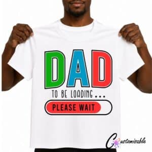 White T-shirt with colourful “Dad To Be Loading Please Wait” DTF transfer design featuring bold red, green, and blue letters with a loading bar graphic.