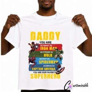White T-shirt with a superhero-inspired “Daddy You Are Our Favourite Superhero” DTF transfer design featuring colourful comic-style graphics and bold text.